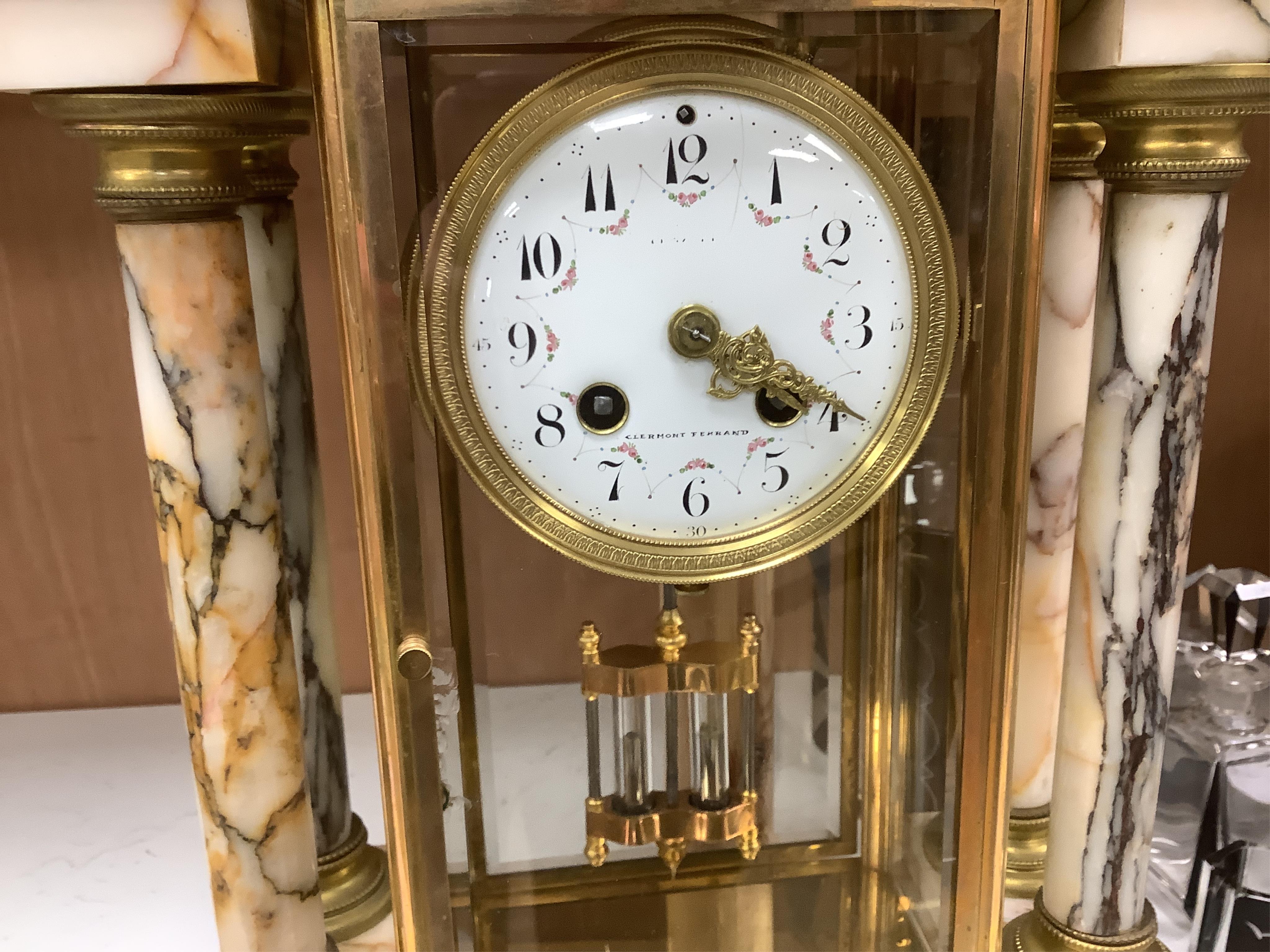 A French marble and gilt bronze four glass portico clock, striking on a coiled gong, 54cm high. Condition - fair to good.